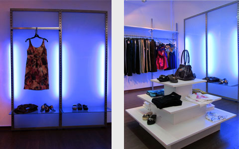 serie marcos, con iluminacion trasera en una tienda de moda, vista general con una piramide con complementos, estanterias con barras y los marcos iluminados